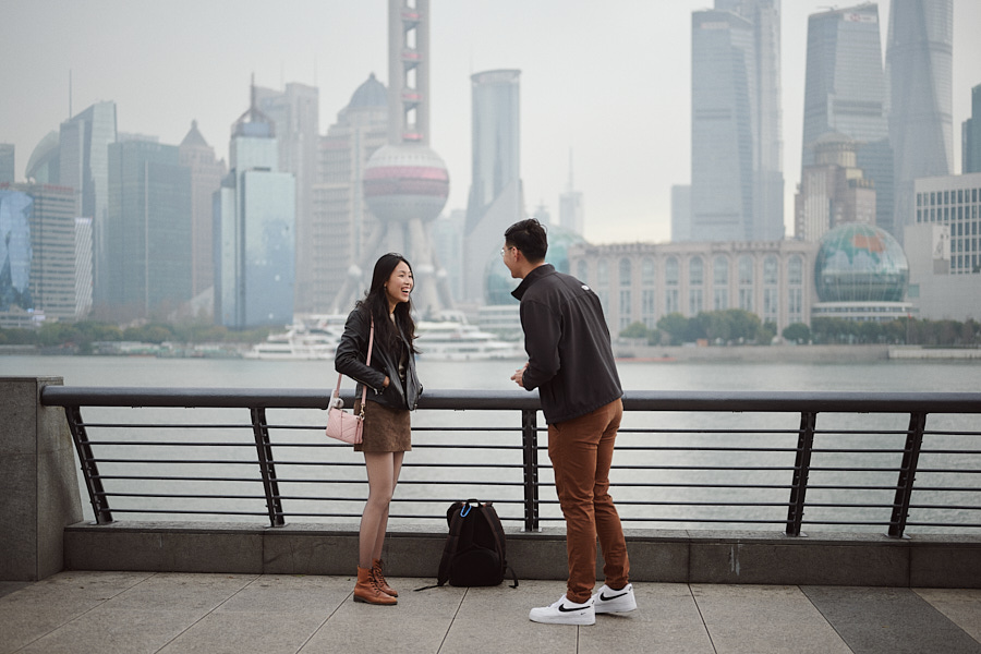 Hong Yun reacting with surprise as Bryan proposes on the Bund in Shanghai.