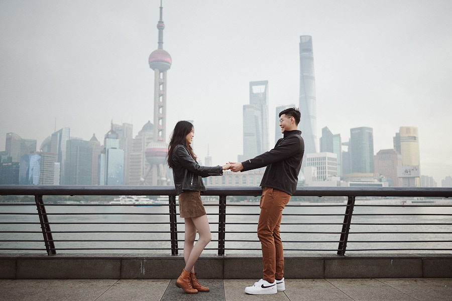 Bryan and Hong Yun celebrating their engagement against the Shanghai skyline.