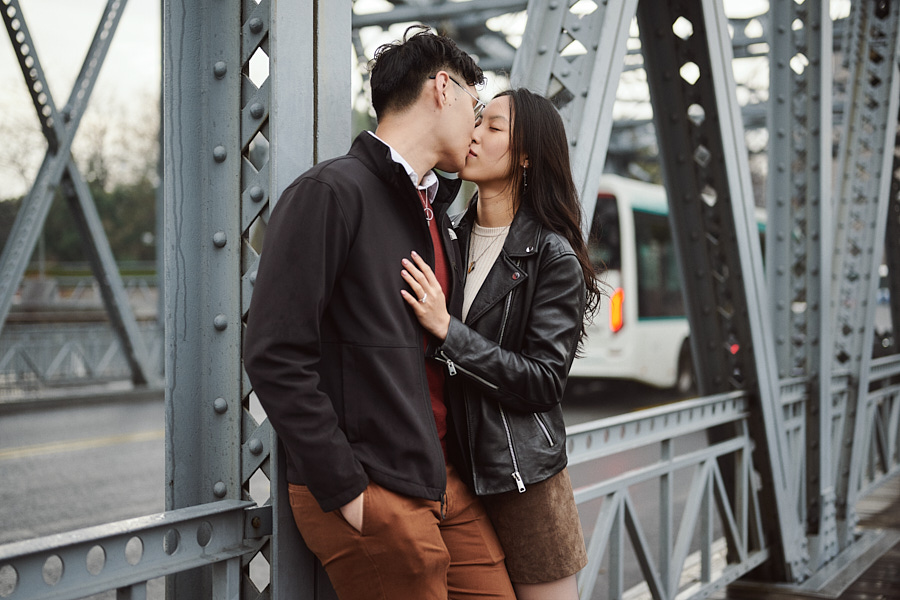 Candid engagement photography near Waibaidu Bridge on a rainy day in Shanghai.