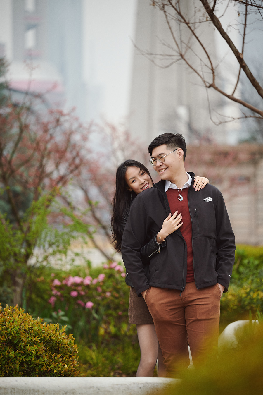 A candid portrait of the newly engaged couple beneath the overcast Shanghai sky.