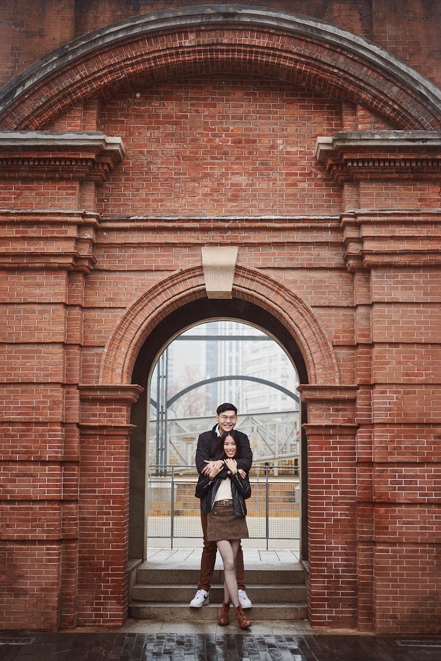 Rain-soaked streets and historic architecture around the Bund during a couple's photoshoot.
